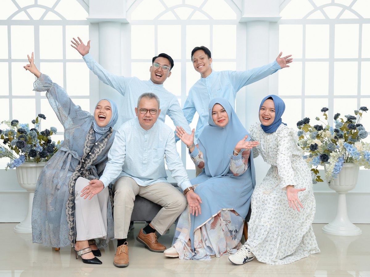 Three generations of a Malaysian family posing happily together